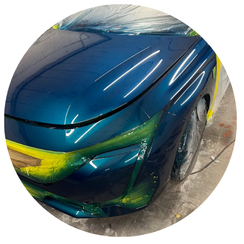 Freshly painted car panel under workshop lights